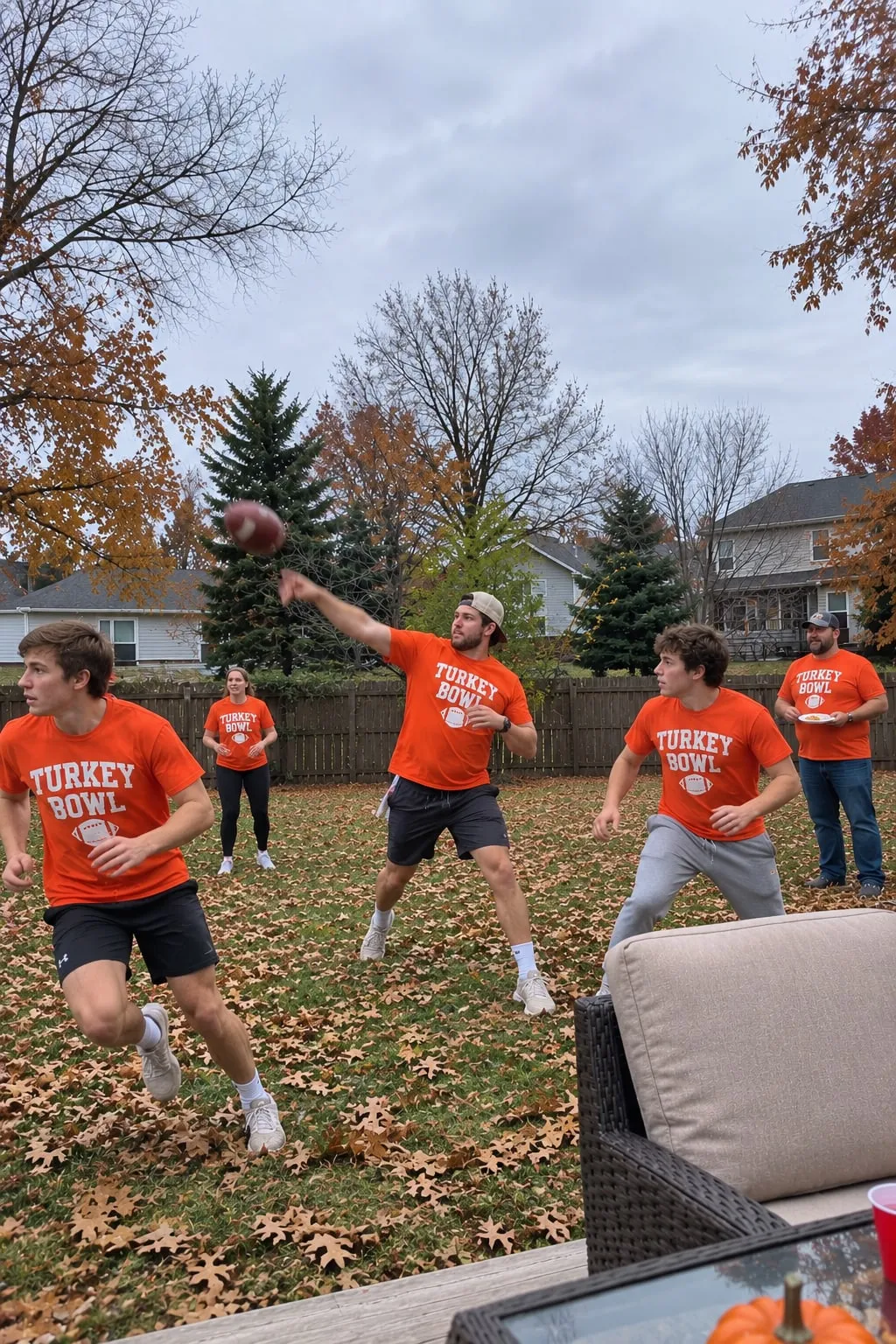 Cousins playing backyard football on Thanksgiving in orange “Turkey Bowl” shirts